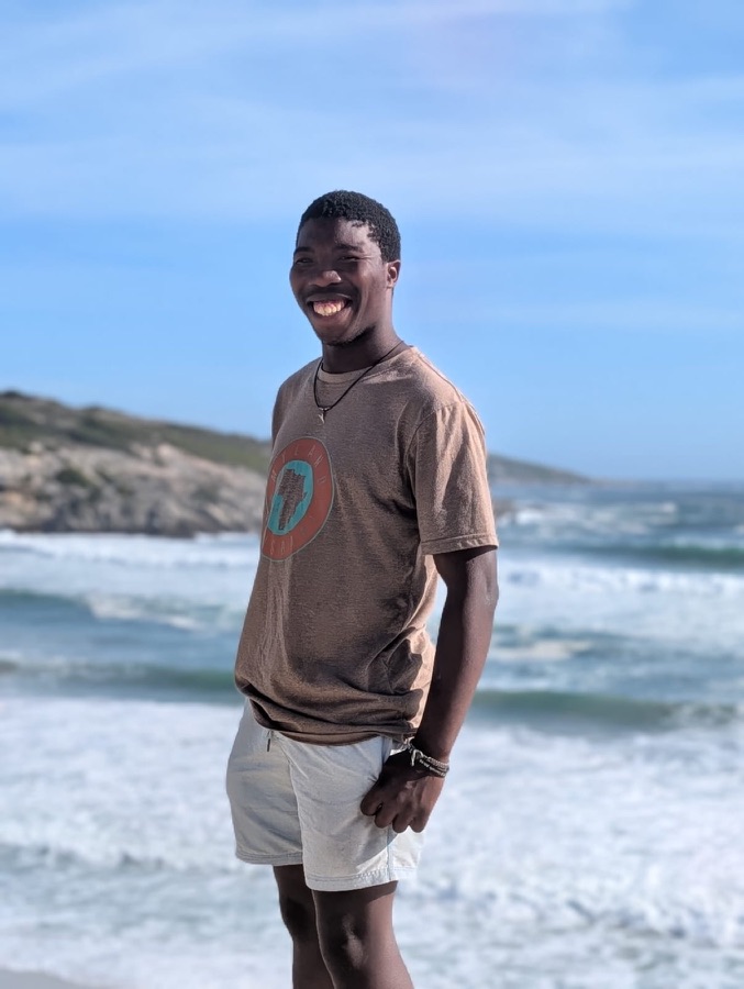 Franco Otto, gardener, smiling by the ocean